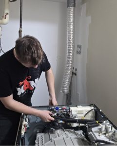 Dryer repair specialist at work