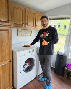 Washer repair technician at work