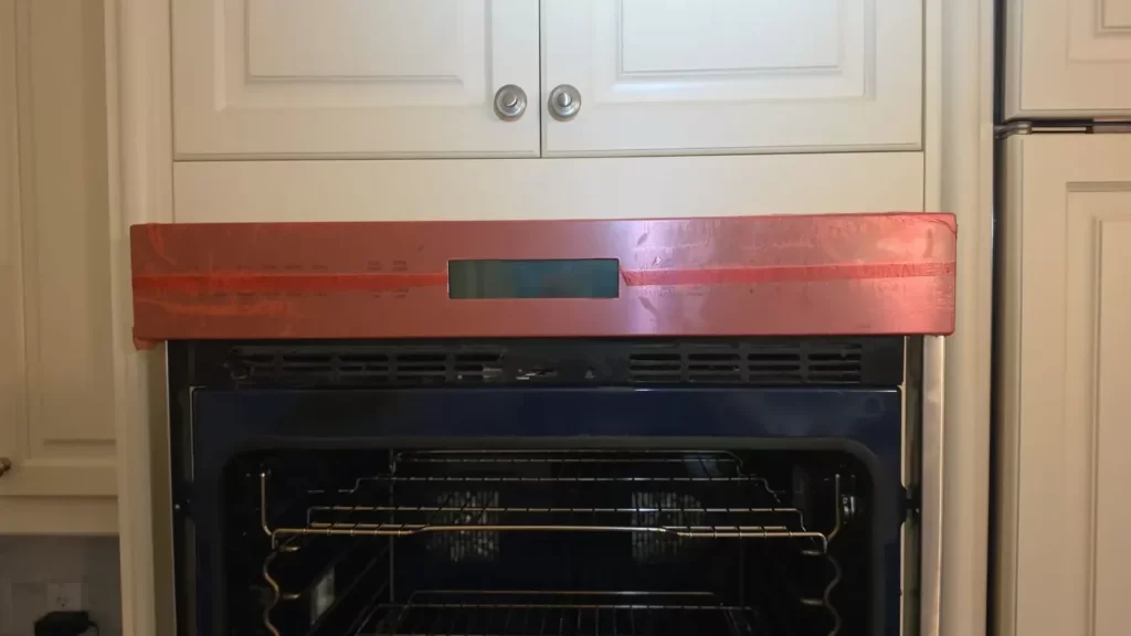 New Wolf user interface panel, still in red protective film, fitted on a built-in wall oven.